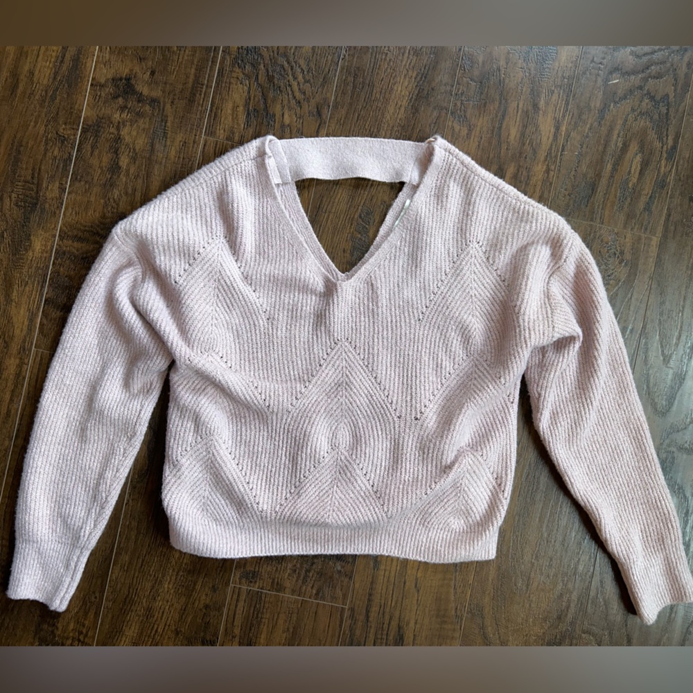 Slightly cropped sweater. V cut in front and back. Never worn